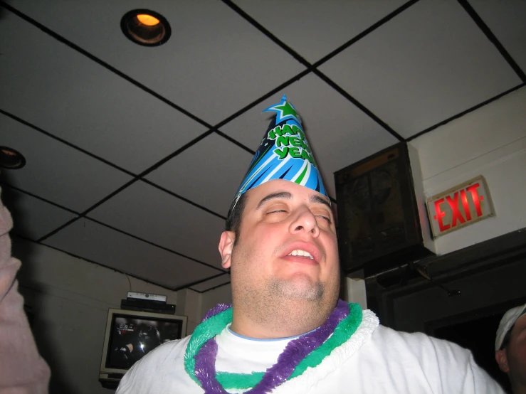 a man wearing a party hat and a lei around his neck