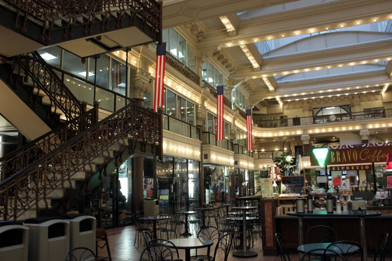 the inside of a mall with many tables and chairs