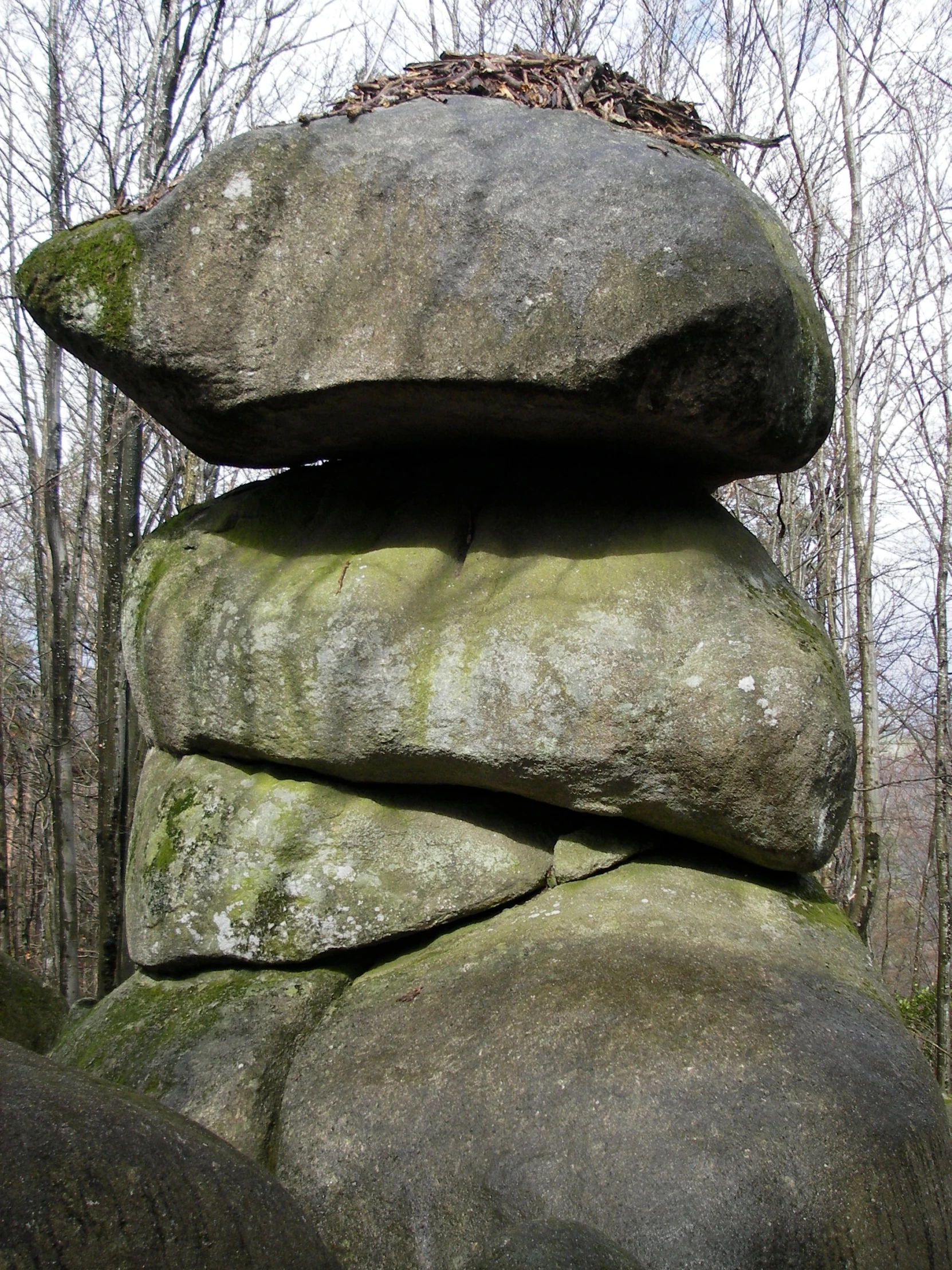 some kind of structure with many layers of rocks in the woods