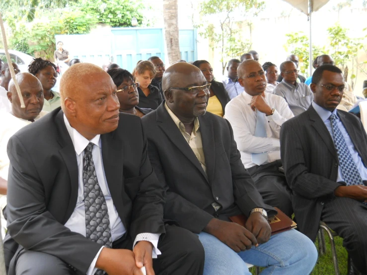 some men are sitting down together and listening