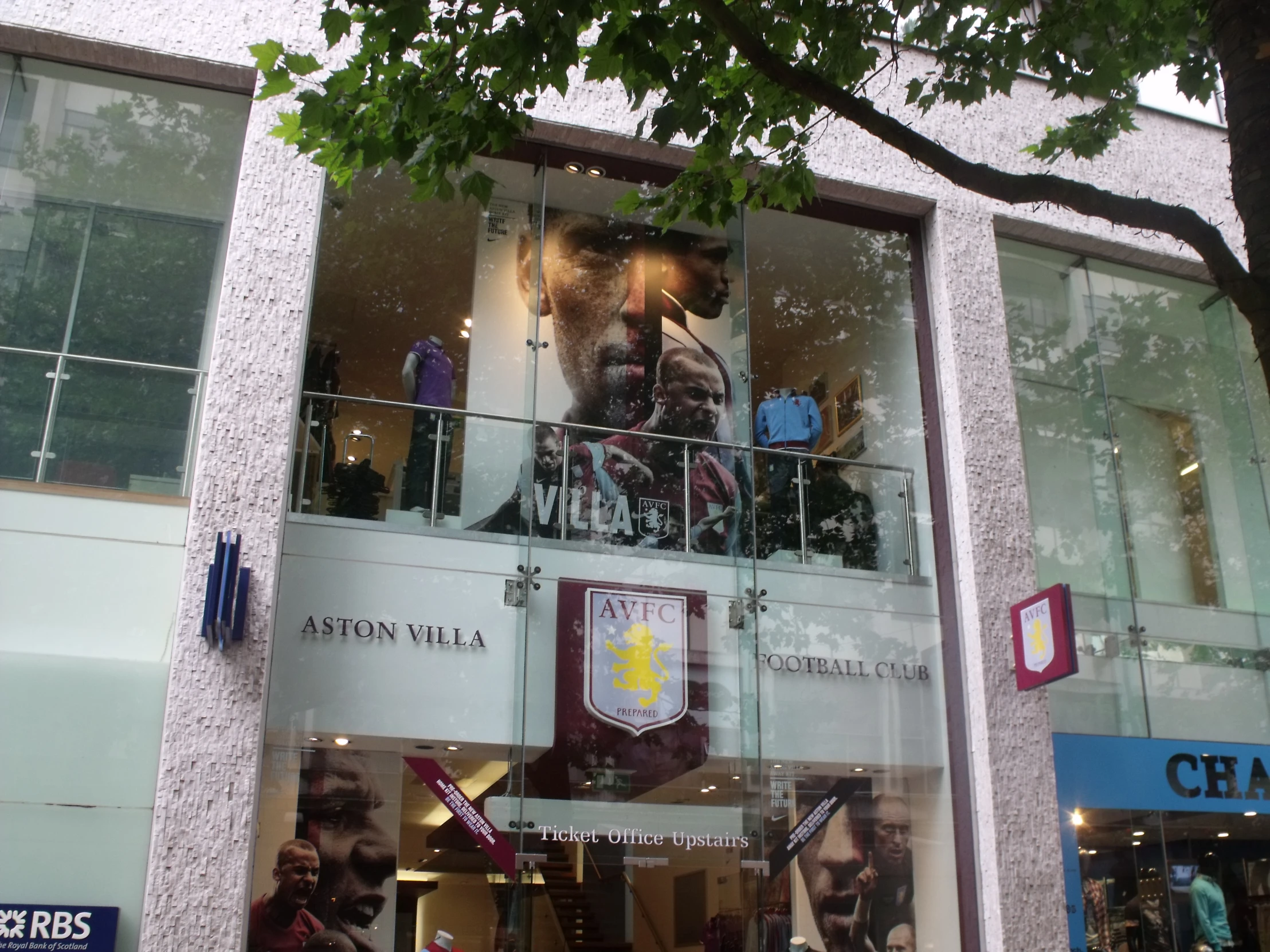 a window on the outside of a building with people walking