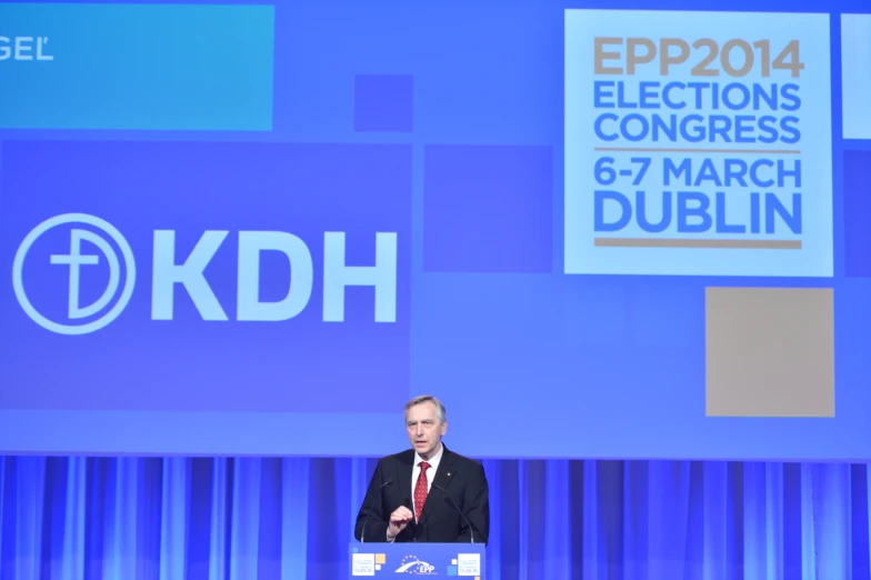 a man standing behind a podium giving a speech