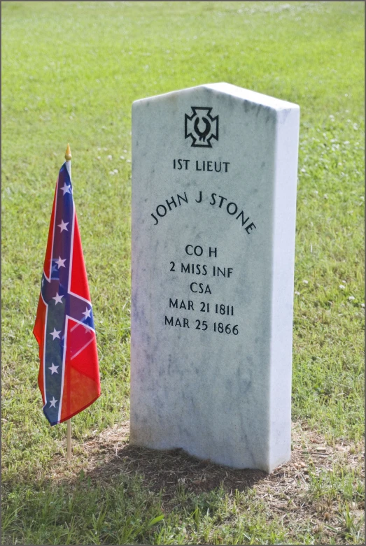 a large grave with two flags sitting next to it