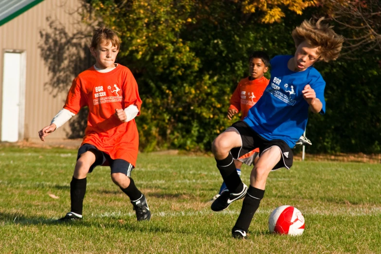 a group of s kicking around a soccer ball