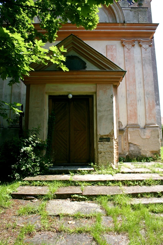 a small church with steps leading to it in the day