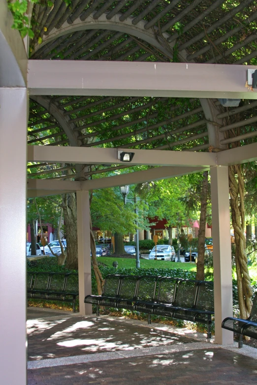 a row of black benches under a covering