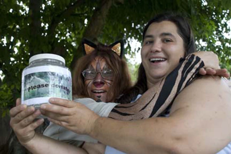 the woman smiles as she shows off her face painted