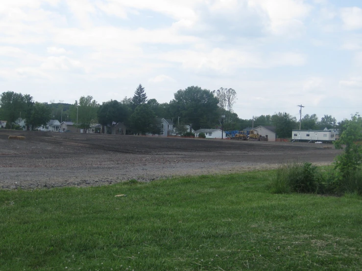 farm land with a lot of green grass in the foreground