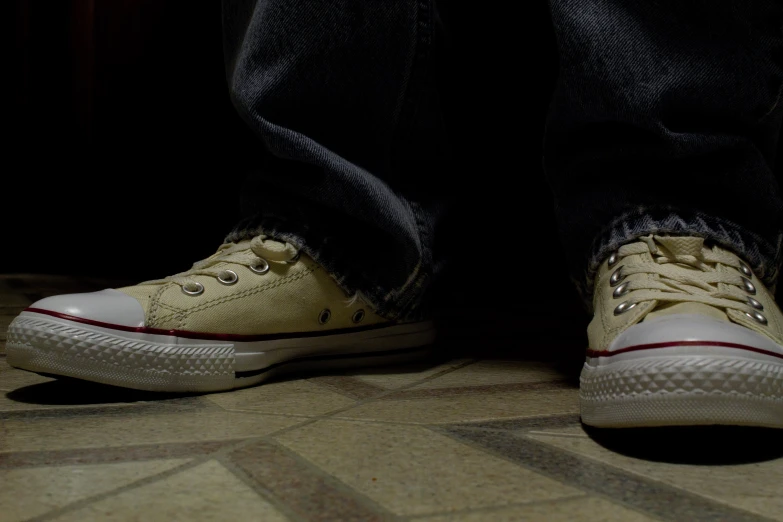 a pair of shoes standing on top of a carpet