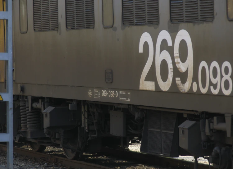 the back of a passenger train with numbers painted on the side