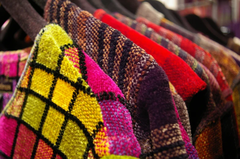 colorful blankets and scarves are displayed together