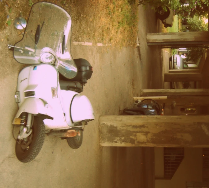 the back end of a scooter parked next to stairs