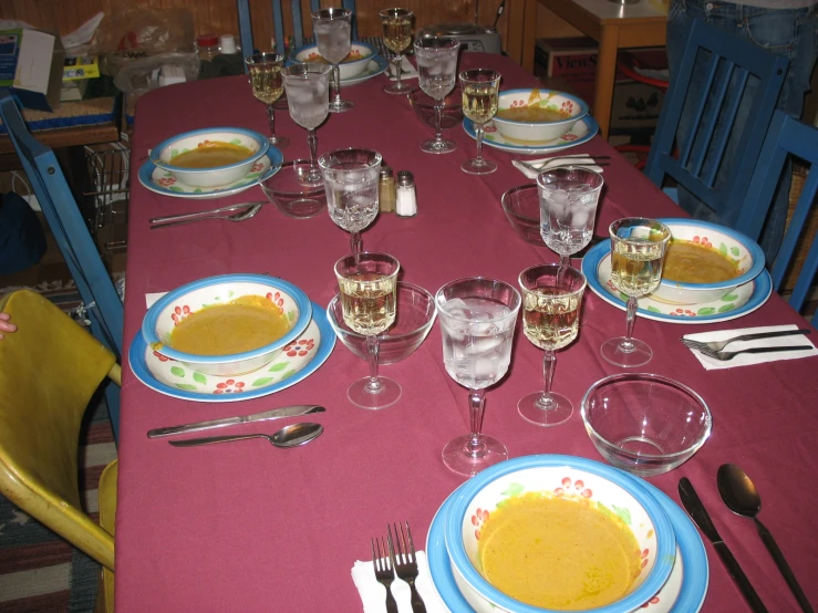 the table is set with dishes and utensils