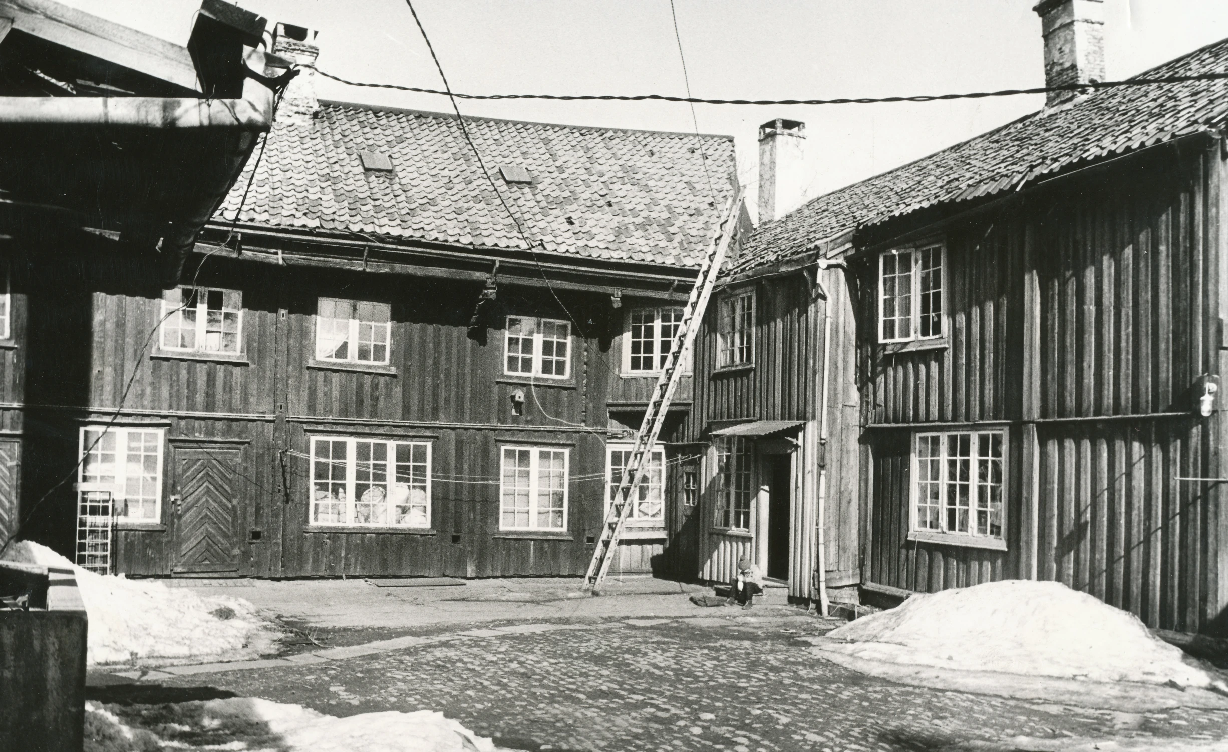 an old house has a ladder going up the side