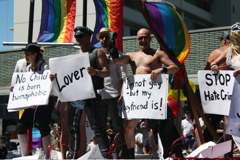 a group of men with  on holding up signs