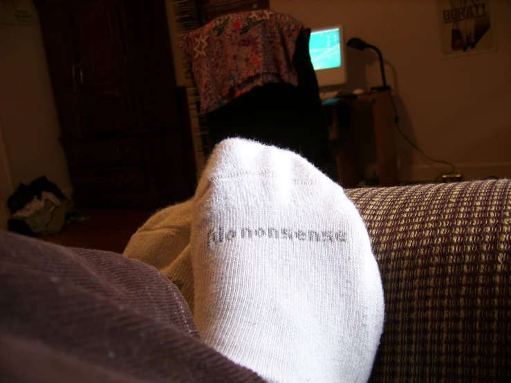 a person's feet wearing a white sock with text on them