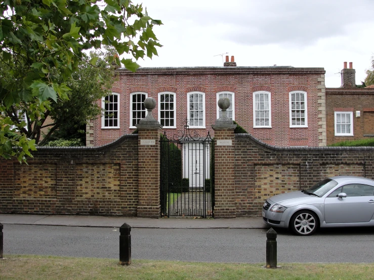 a grey sports car parked by a building