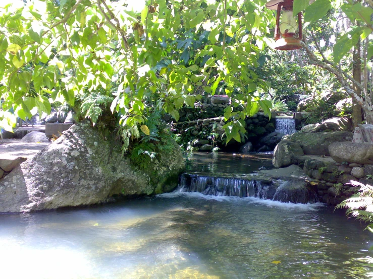 small river with blue water and a waterfall