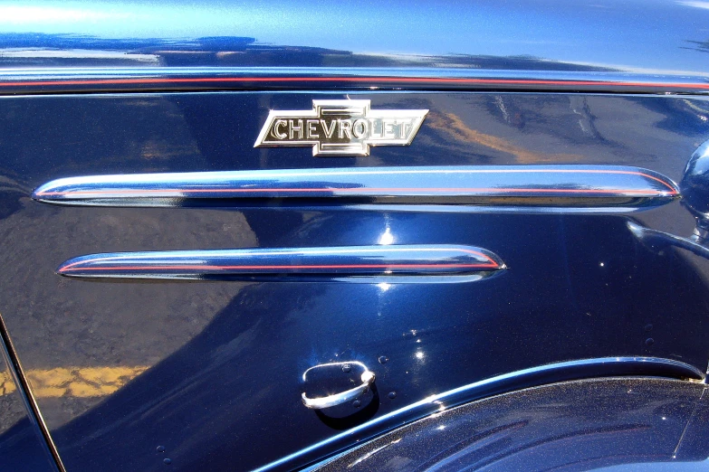 the hood or badge of a blue classic car