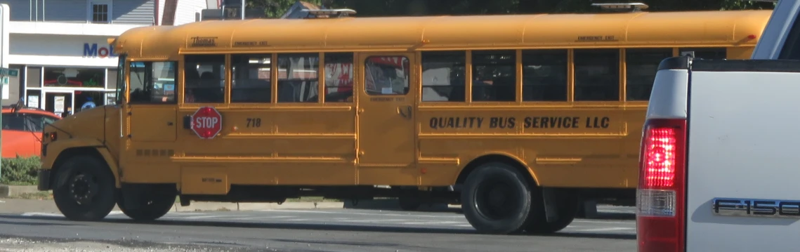 a large yellow school bus traveling down the street