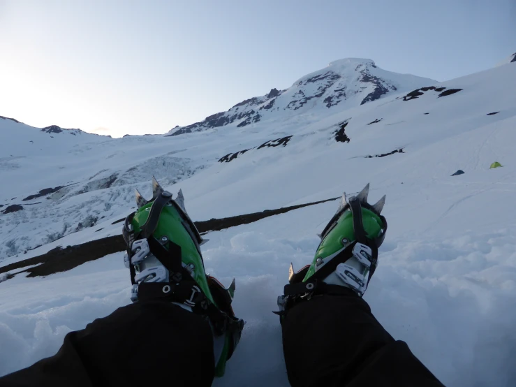the feet of someone skiing on a mountain covered in snow