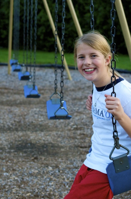 a girl smiling while playing in the park