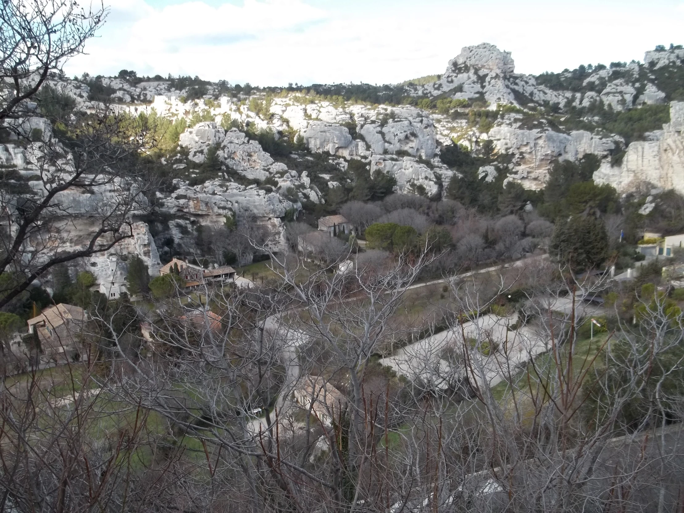 a view from atop the valley of rocks, in the distance is trees and a mountain