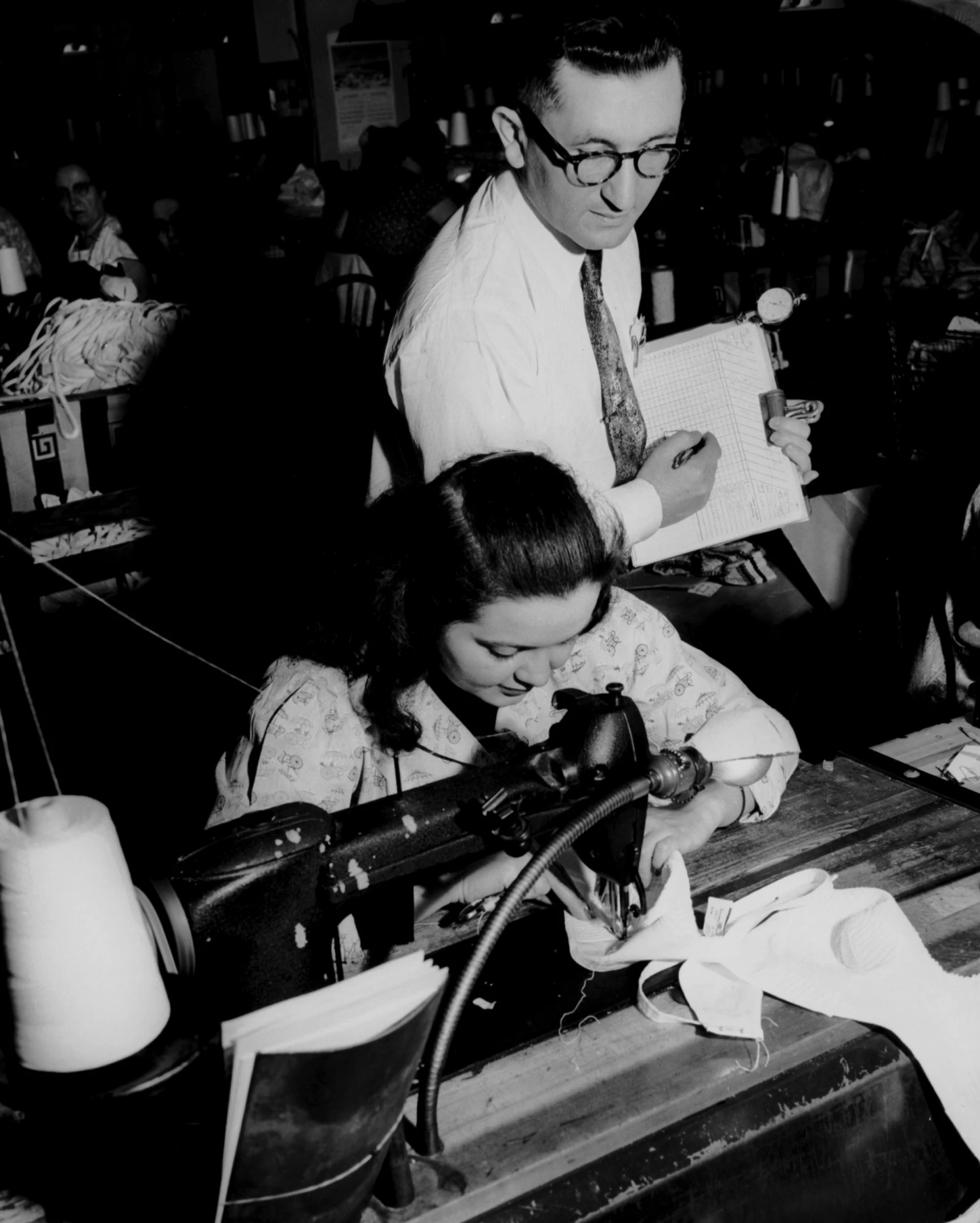 a man and woman looking at some type of equipment in a shop