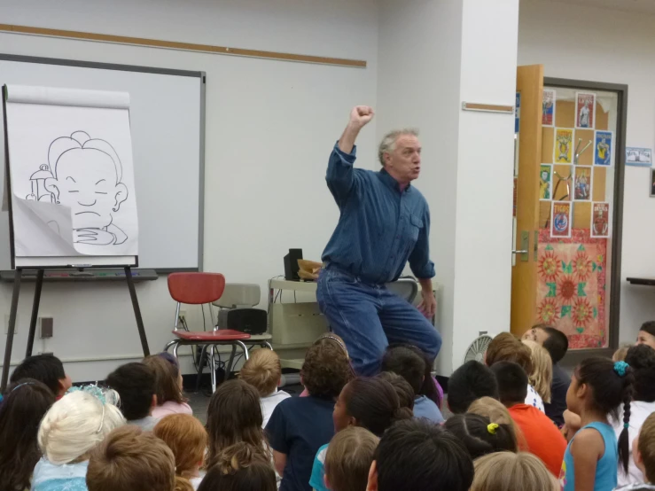 a man is giving a presentation to children