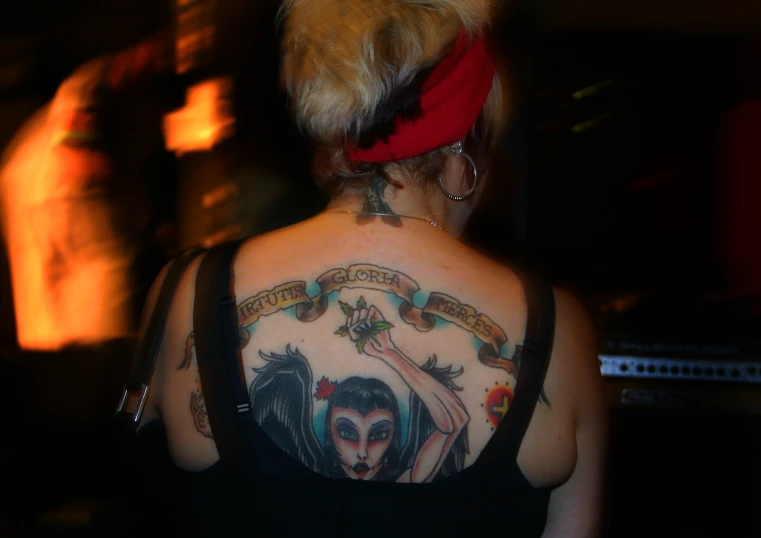 the back of a woman wearing a tattoo is shown