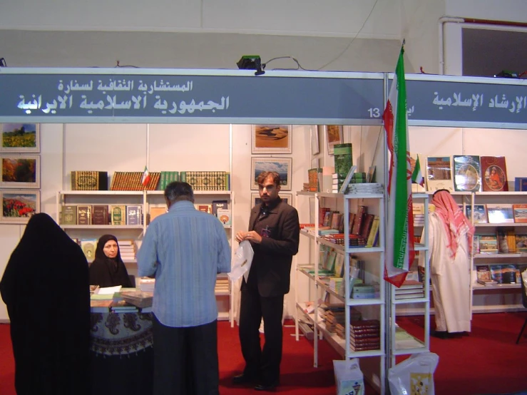 a woman and two men standing inside of a shop