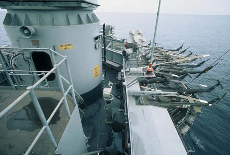 a group of large navy ships parked on the water