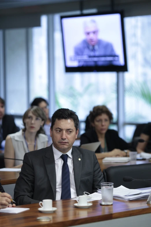 a man is sitting in front of a meeting