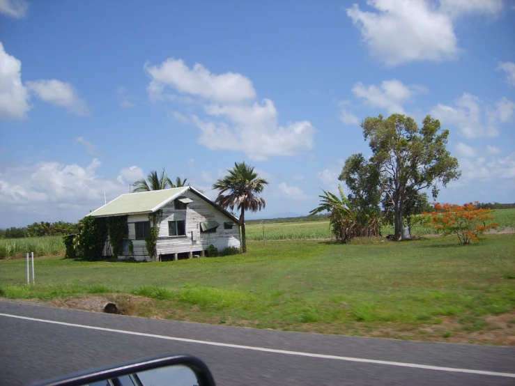 a white house in a green field