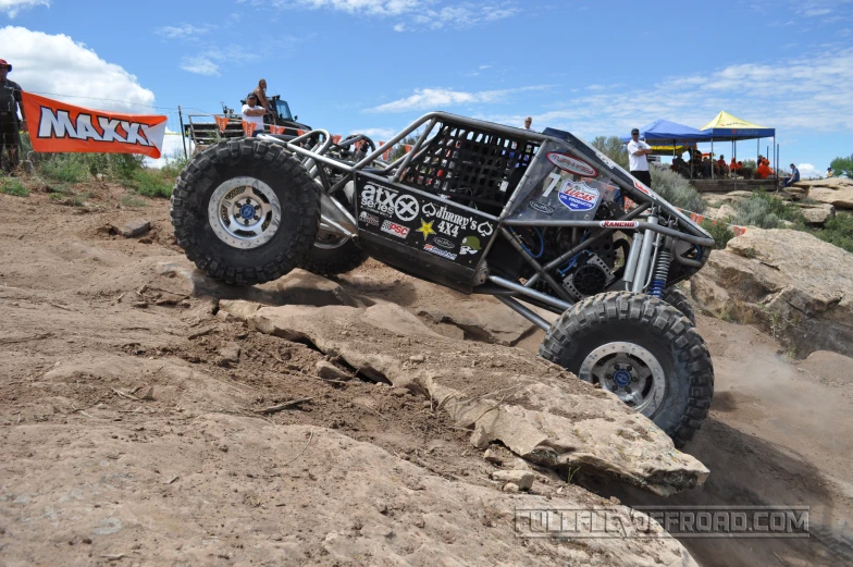 a race car moving down the dirt track