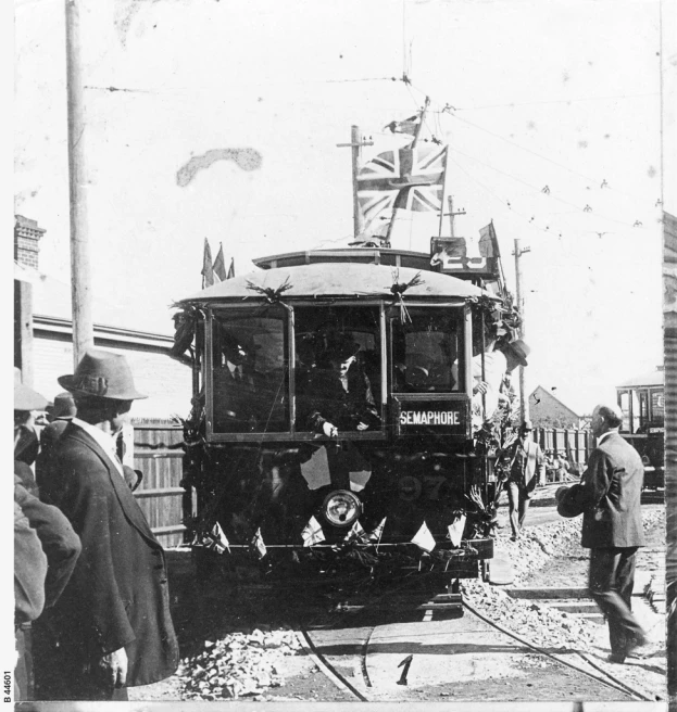 old style train being unloaded with people and union flags