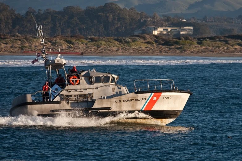 an officer is on the boat traveling in the water