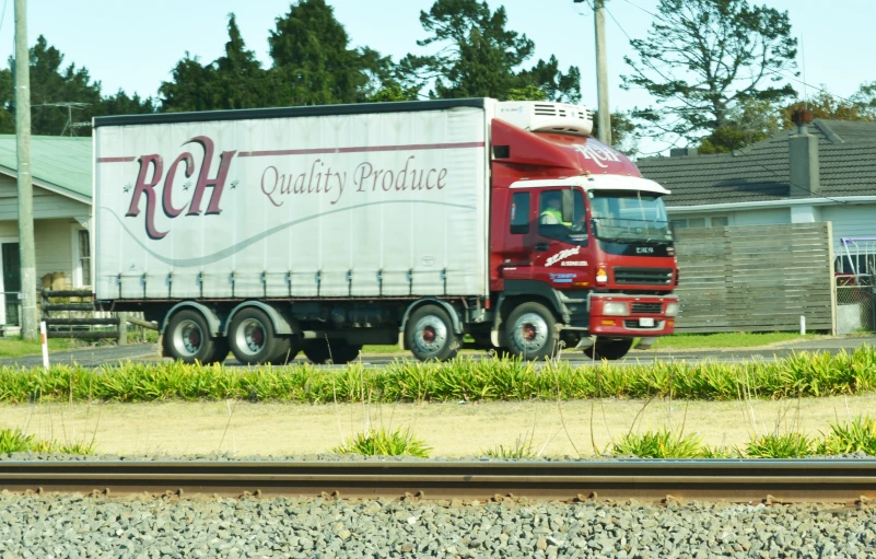 a large truck traveling down the road near houses