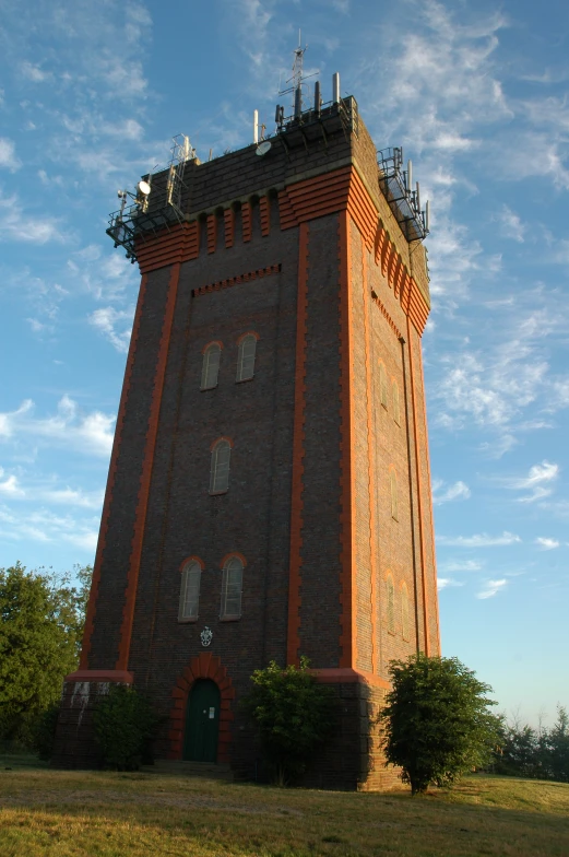 a large building with a green door in a field