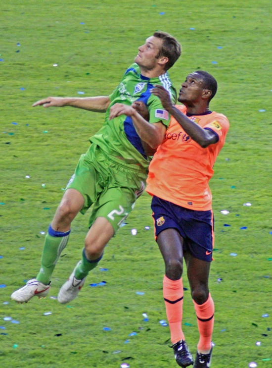 two soccer players compete for the ball during a game