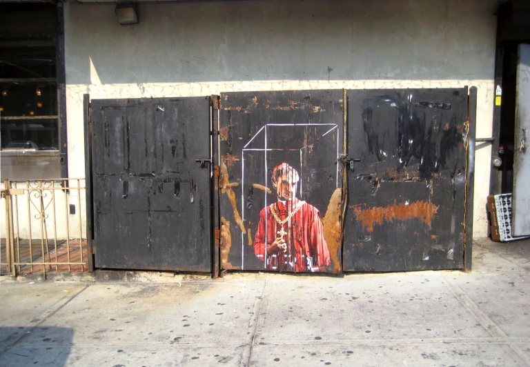 a painting of a man with a cross painted on the side of a building