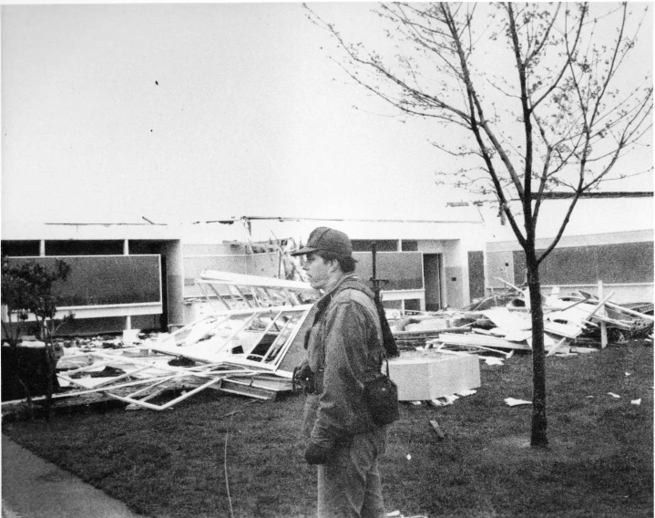 a black and white image of a man looking over construction