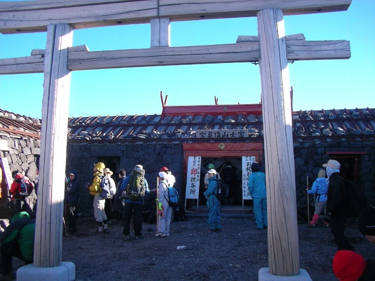 many people outside of a building with columns