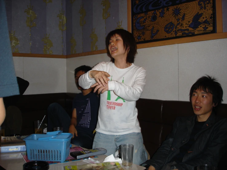 two men and a woman sitting at a table and some food