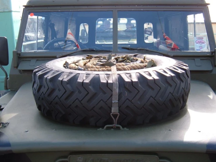 there is a tire sitting on top of a jeep