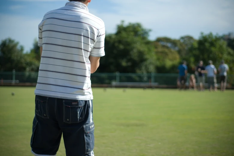 the back view of a man in shorts and shirt