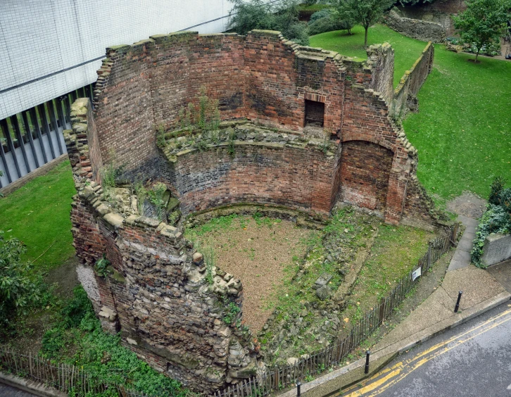 an aerial view of an old building in the middle of a park