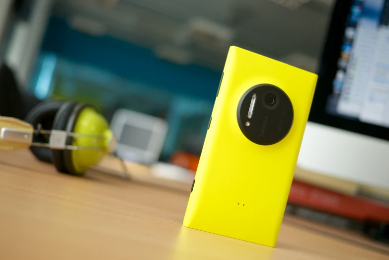 an electronic device sitting on a desk with headphones on it