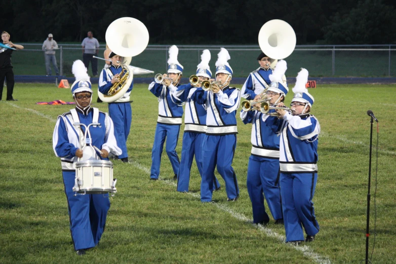 a group of male and female marching students playing on the field