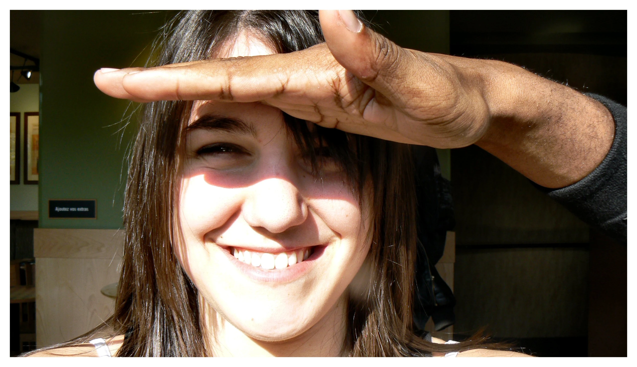 a young woman has her hand under her face